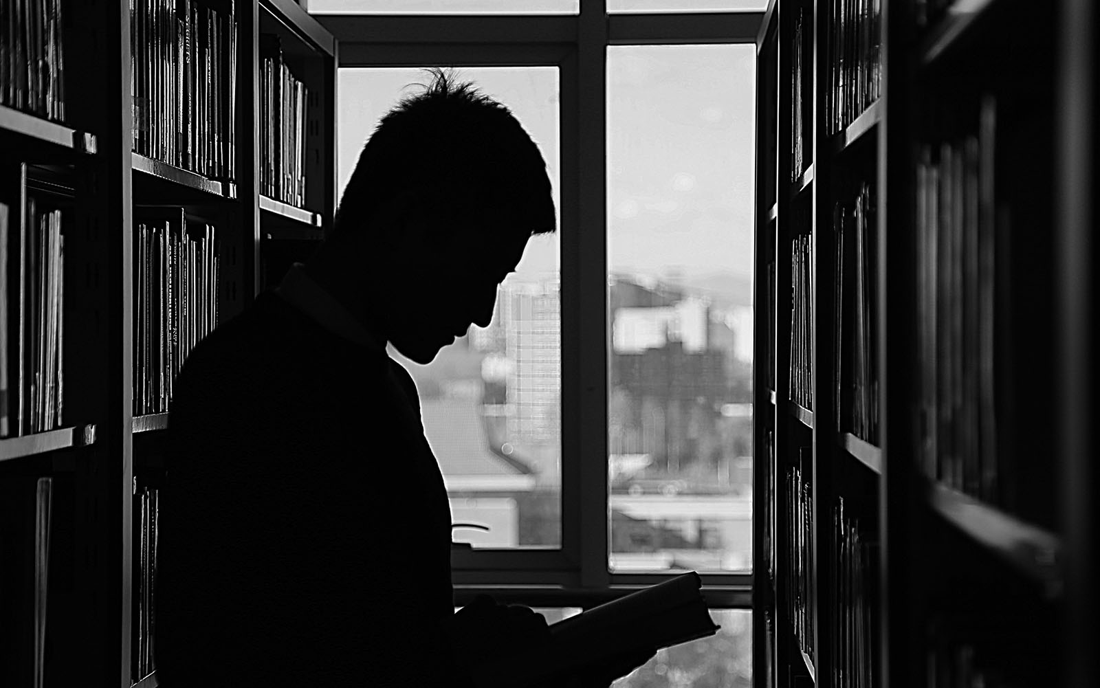 Man in library exploring challenges faced by children and ways to support their understanding of executive function.