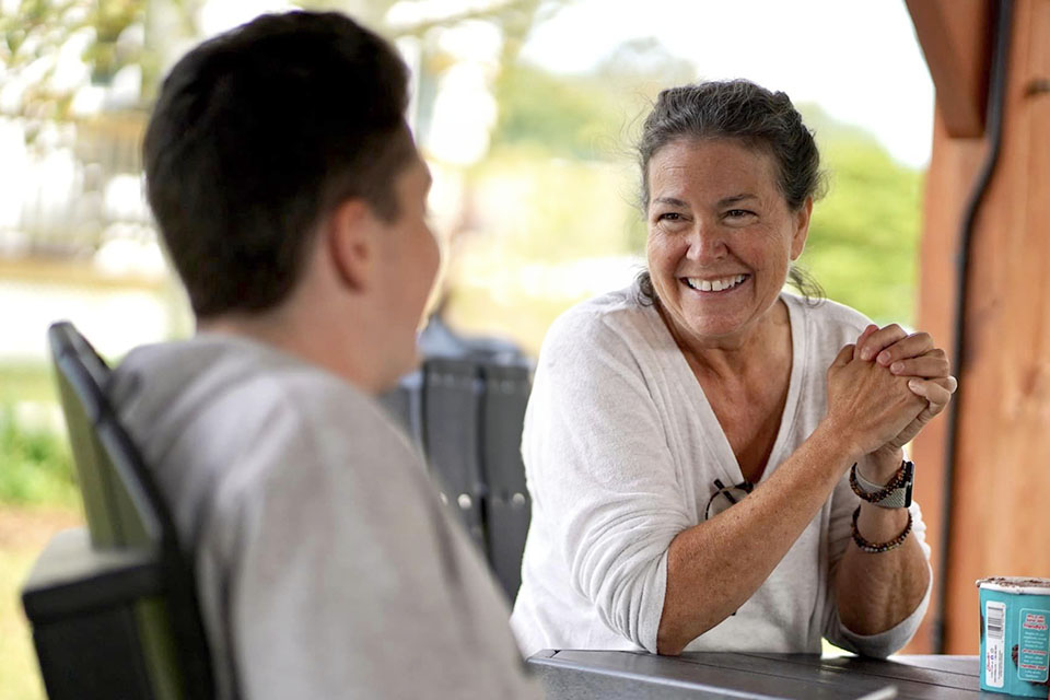 A woman enjoying a cup of coffee at a table.