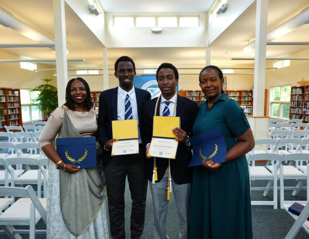 A group of people standing in a library.