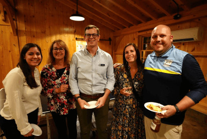 A group of people standing in a room.