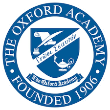 Circular logo for The Oxford Academy, founded 1906, with a blue shield showing a lamp, books, quill, and Greek text, surrounded by the school’s name.
